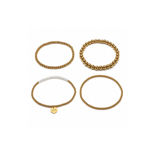 Four beaded stretch bracelets arranged in a 2x2 grid on a plain white background. Three bracelets are metallic gold, and one is white with a small gold circular charm.