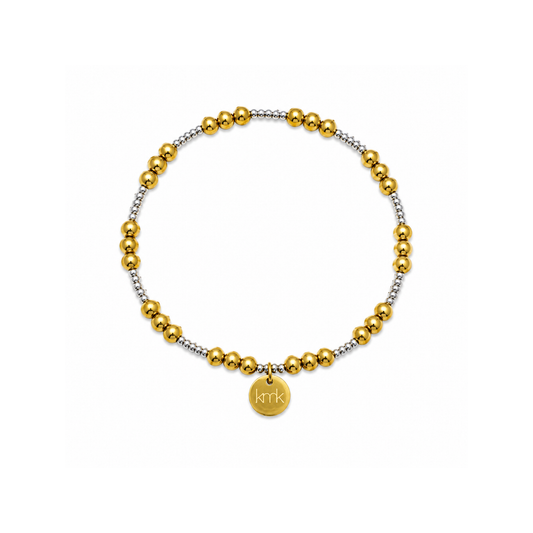 A beaded stretch bracelet featuring alternating polished gold and textured silver beads, with a small round gold disc charm engraved with the name 'krik'.