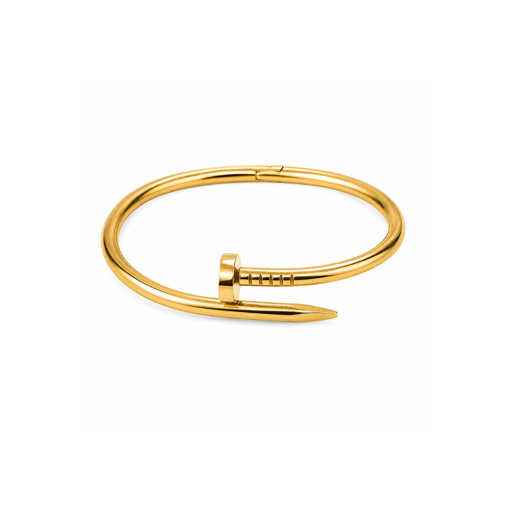 A polished gold-toned metal cuff bracelet with a pointed barrette closure, shown on a clean white background.