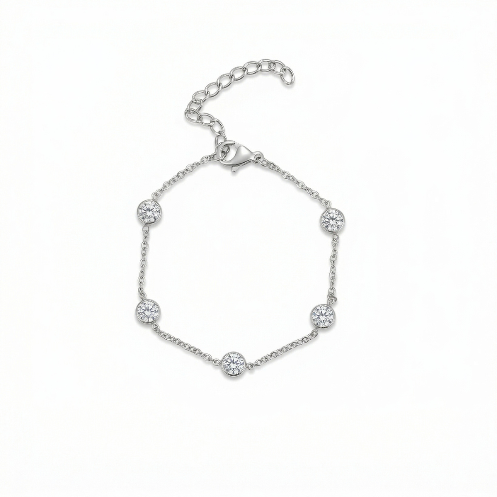 Silver bracelet with small round embellishments on a white background