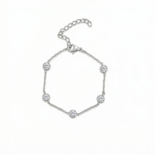 Silver bracelet with small round embellishments on a white background