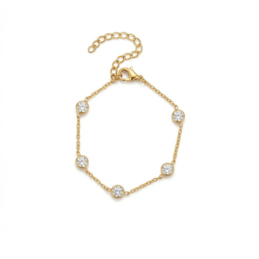 Gold bracelet with diamond-like beads on a white background