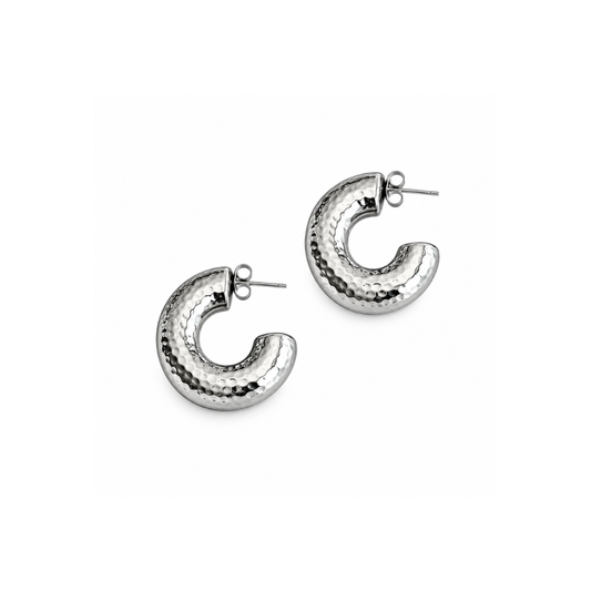 A pair of hammered silver crescent-shaped hoop earrings with post backs, displayed on a clean white background.
