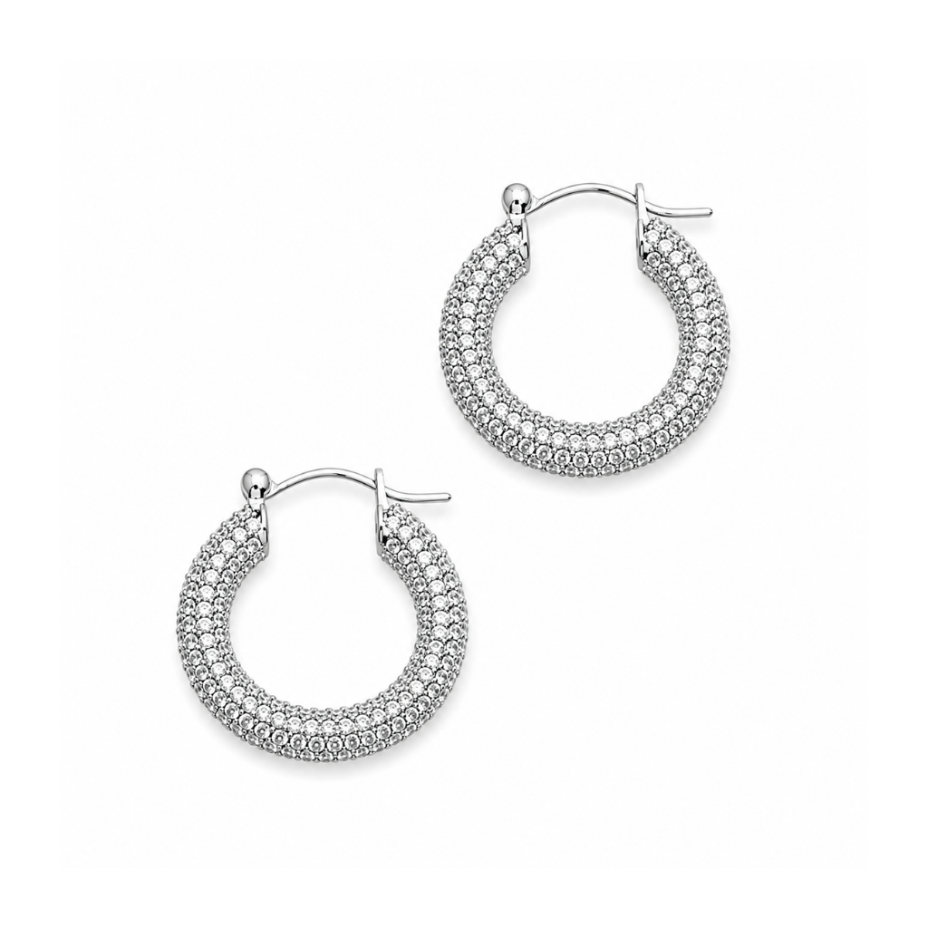 A pair of silver hoop earrings adorned with rows of small clear pavé stones, displayed on a clean white background.