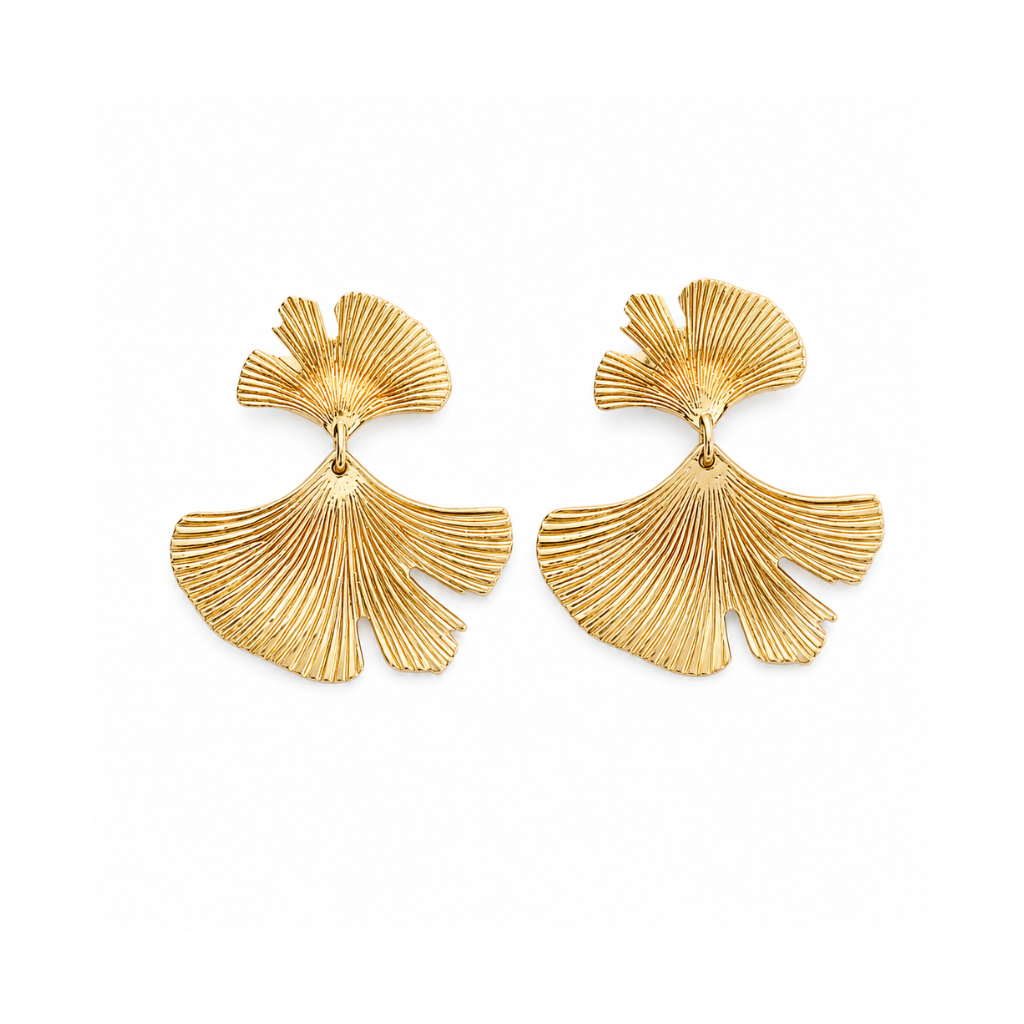 A pair of gold-toned ginkgo leaf drop earrings with a textured, ribbed surface, displayed on a clean white background.
