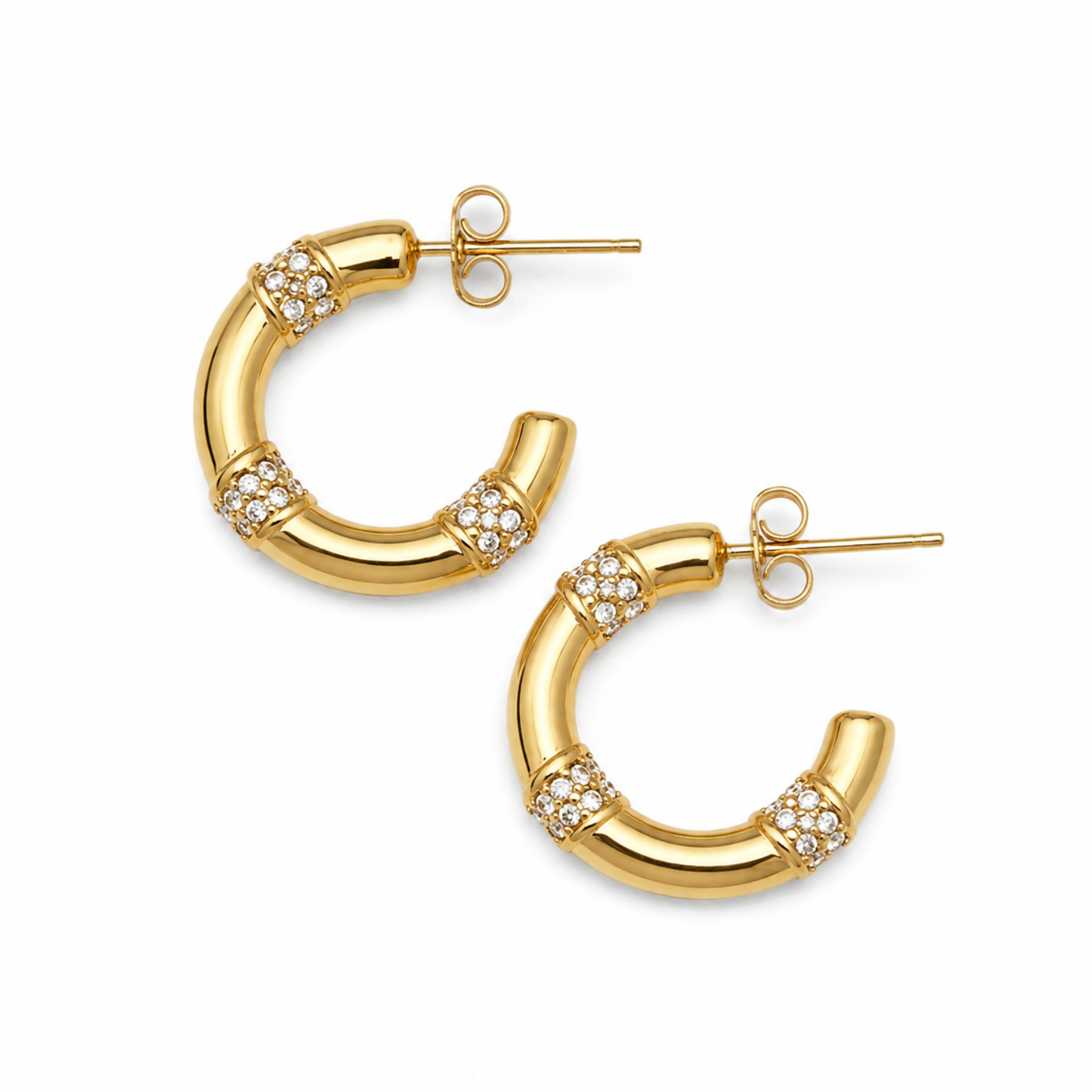 A pair of gold hoop earrings with a bamboo-inspired segmented design, each accented with small clusters of clear pavé stones, shown on a plain white background.