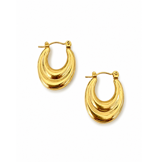 A pair of gold crescent-shaped hoop earrings with a textured, ridged surface and post-back closures, shown on a plain white background.