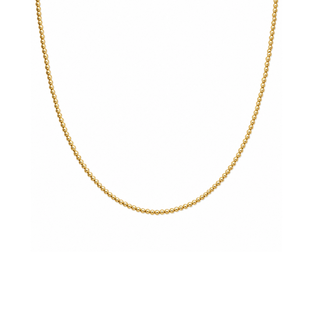 A delicate gold beaded chain necklace displayed against a solid white background.