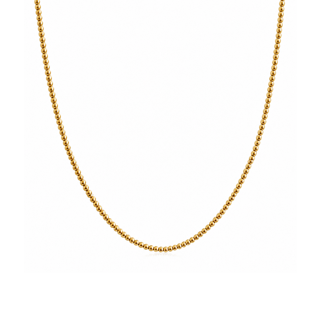 A delicate gold beaded chain necklace, shown draped in a U-shape against a solid white background.