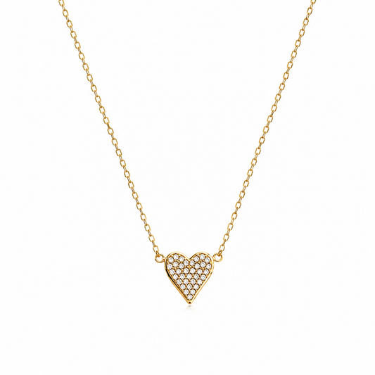 A delicate gold chain necklace featuring a small heart-shaped pendant paved with clear stones, displayed against a solid white background.