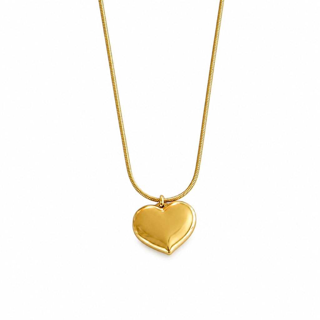 A polished yellow gold heart-shaped pendant necklace on a matching gold snake chain, shown against a plain white background.