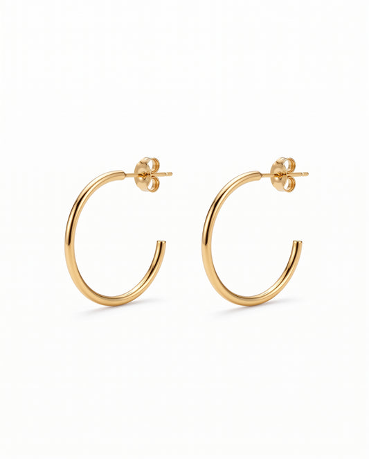 A pair of gold open hoop earrings with flat backings, displayed on a clean white background.